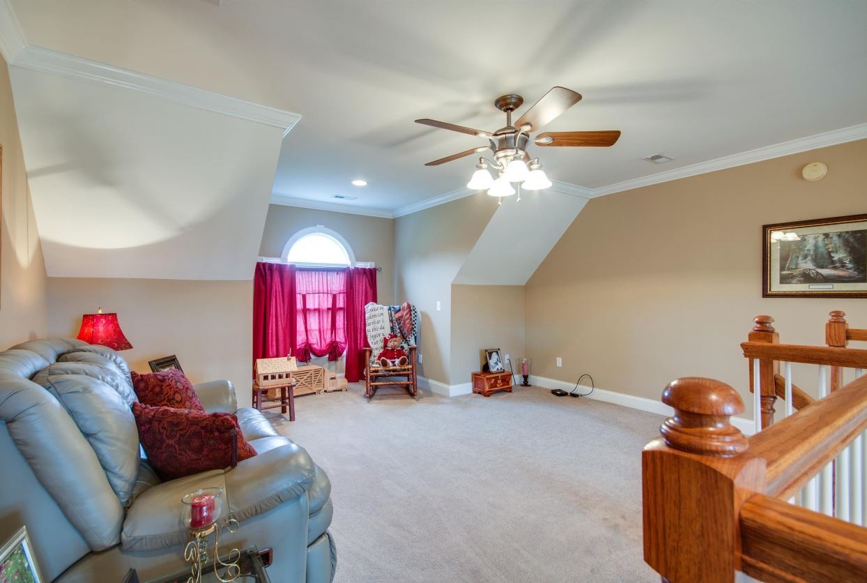 92 Freeman Court Winchester, TN 37398 - Photo 18 of 19 a living room with furniture gym equipment and a chandelier