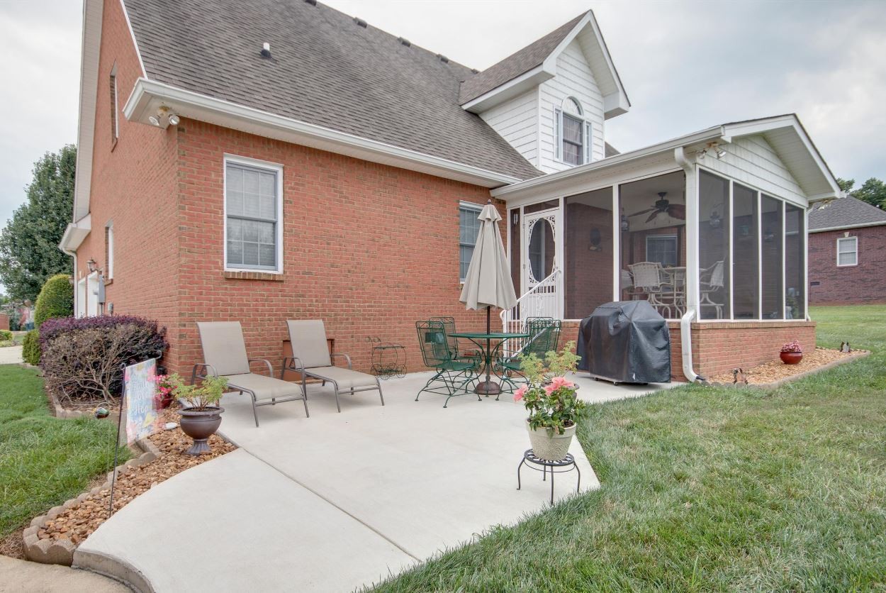 92 Freeman Court Winchester, TN 37398 - Photo 3 of 19 a view of a patio with couches chairs potted plants and wooden fence