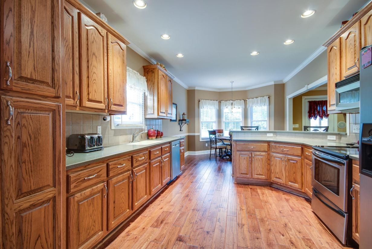 92 Freeman Court Winchester, TN 37398 - Photo 10 of 19 a kitchen with stainless steel appliances granite countertop wooden cabinets a refrigerator a sink a stove and a wooden floors