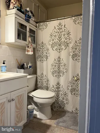 a bathroom with a toilet sink and shower