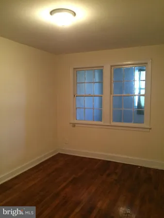a view of wooden floor and windows in a room