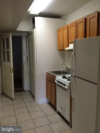 a kitchen with a stove top oven and cabinets