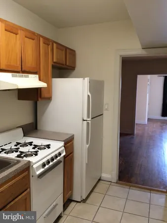a kitchen with a stove and a refrigerator