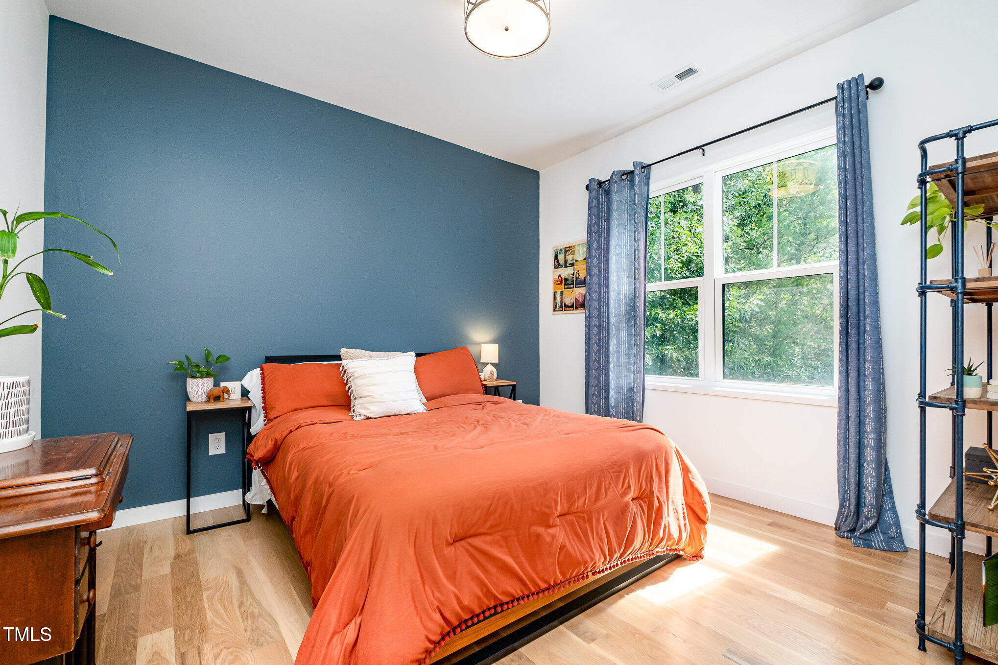 517 Bart Street Raleigh, NC 27610 - Photo 17 of 43 a bedroom with a bed and wooden floor