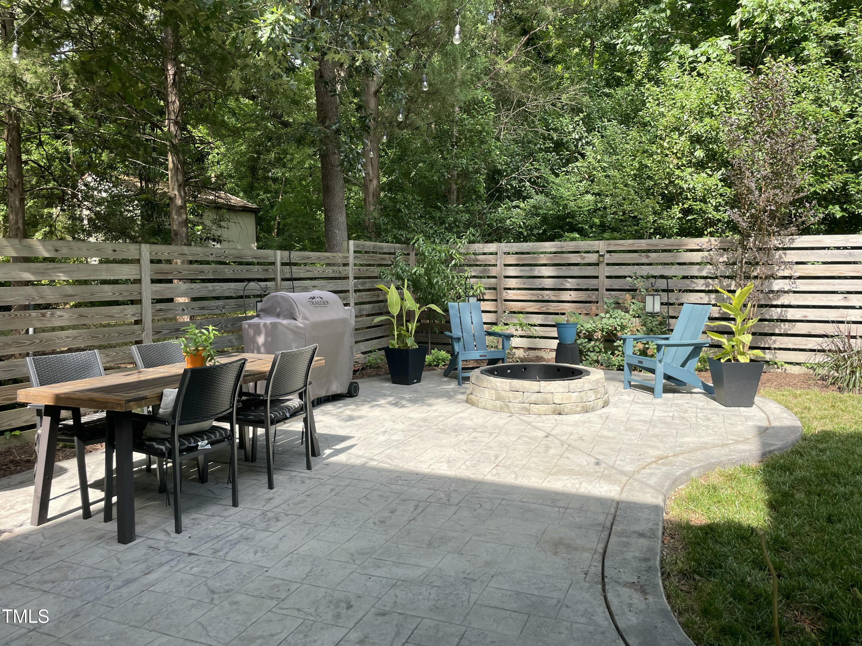 517 Bart Street Raleigh, NC 27610 - Photo 28 of 43 a view of a patio with table and chairs potted plants with wooden fence
