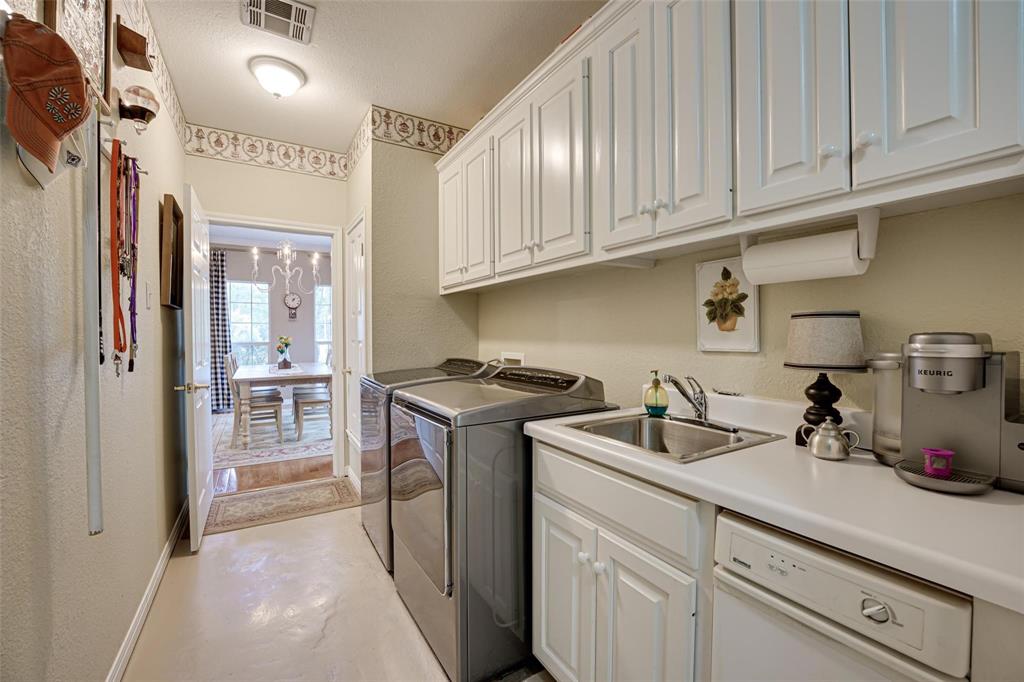 32018 Dove Trail Whitney, TX 76692 - Photo 12 of 36 a kitchen with stainless steel appliances granite countertop a sink a stove and a refrigerator