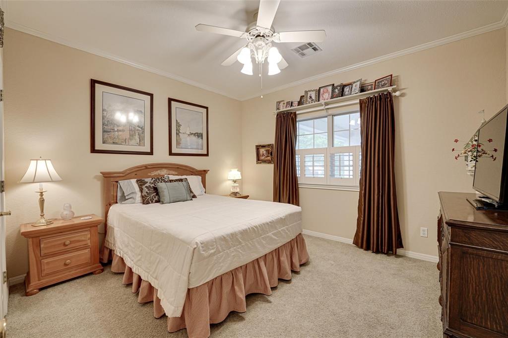 32018 Dove Trail Whitney, TX 76692 - Photo 18 of 36 a bedroom with a bed and a tv on the dresser