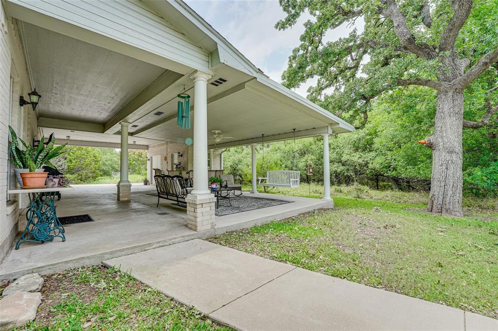 32018 Dove Trail Whitney, TX 76692 - Photo 23 of 36 a view of a house with backyard and porch