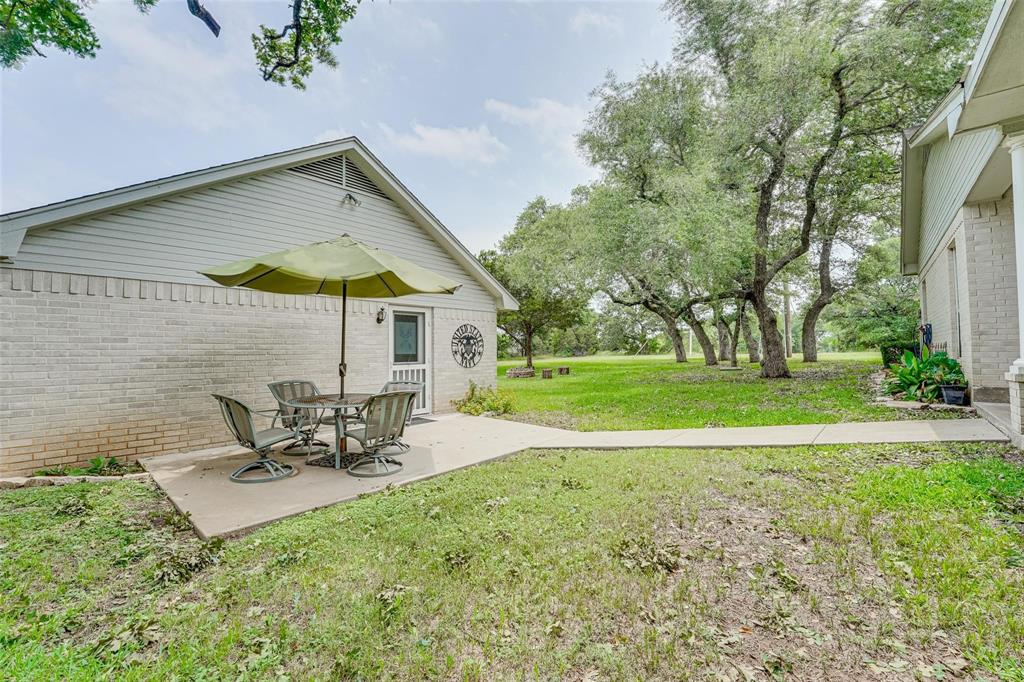32018 Dove Trail Whitney, TX 76692 - Photo 24 of 36 a view of a house with backyard and sitting area
