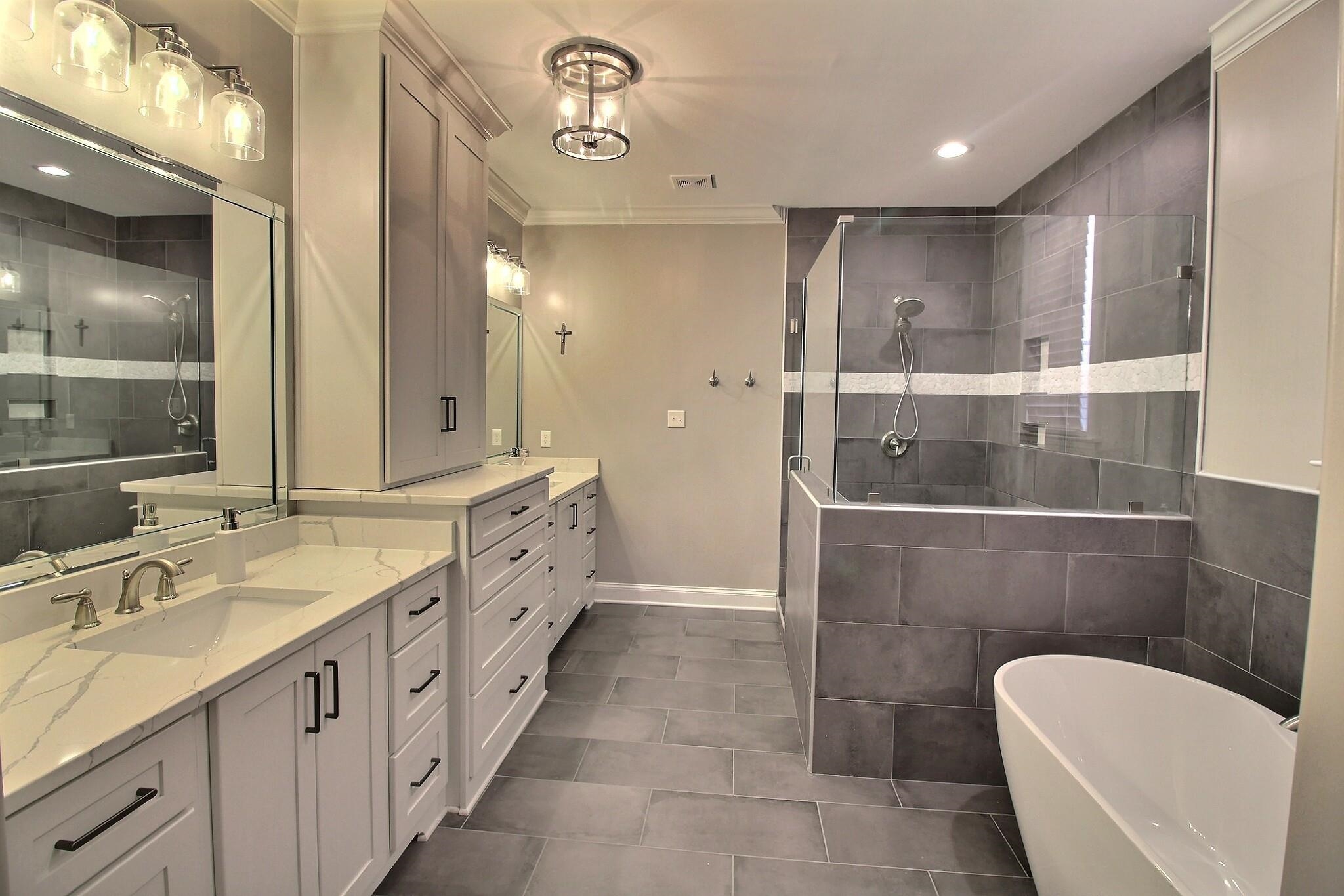 1254 Percheron Pass Collierville, TN 38017 - Photo 11 of 32 a bathroom with a double vanity sink and mirror with bathtub