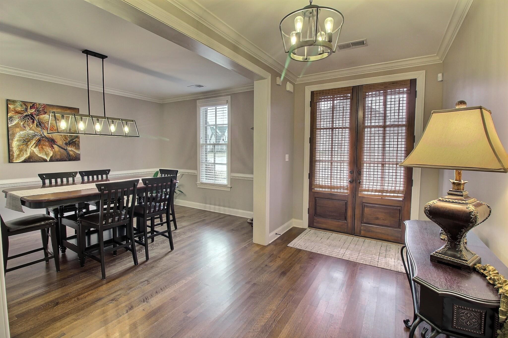 1254 Percheron Pass Collierville, TN 38017 - Photo 2 of 32 a view of a dining room with furniture a chandelier and wooden floor