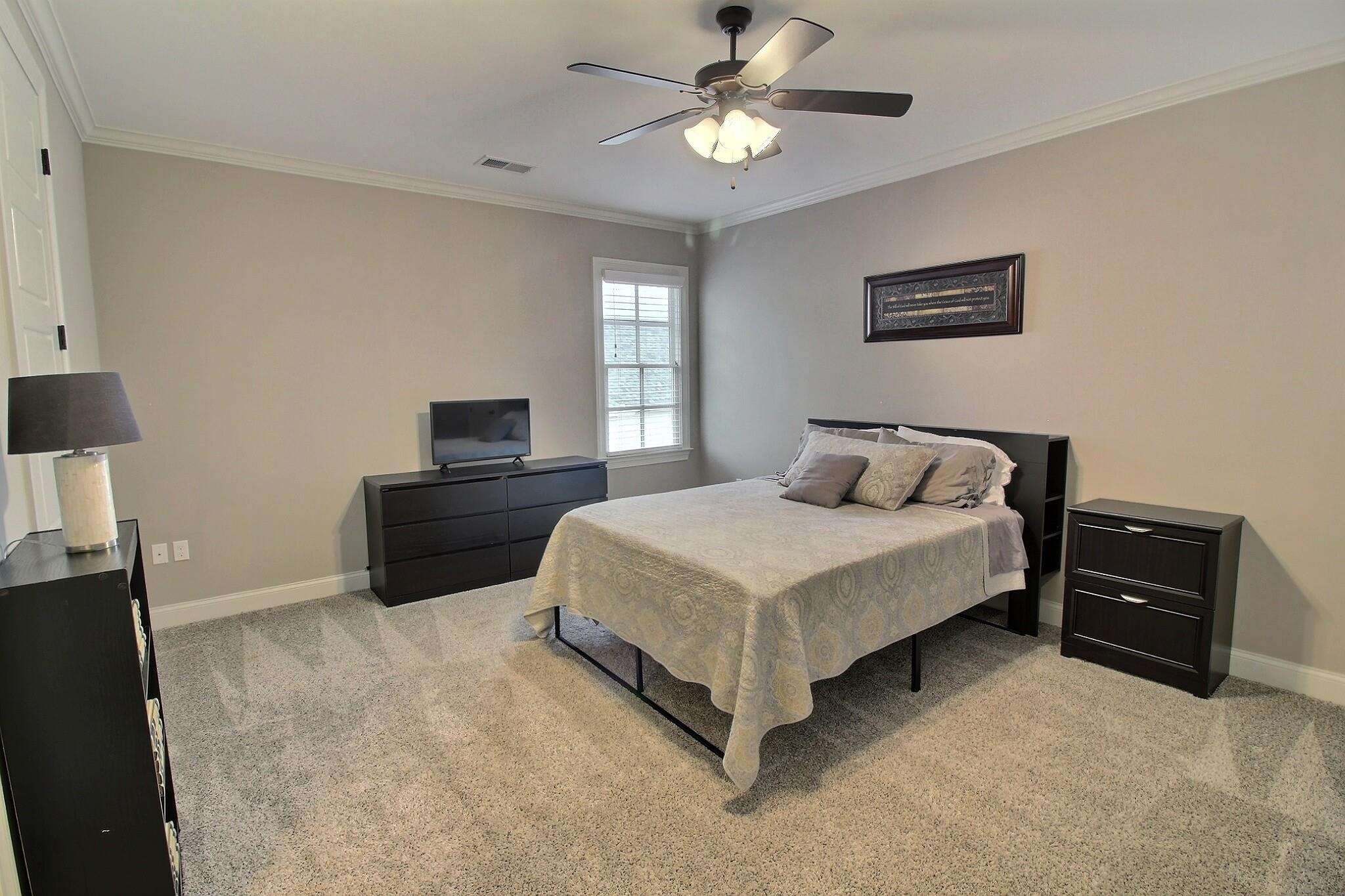 1254 Percheron Pass Collierville, TN 38017 - Photo 21 of 32 a bedroom with a bed and a tv