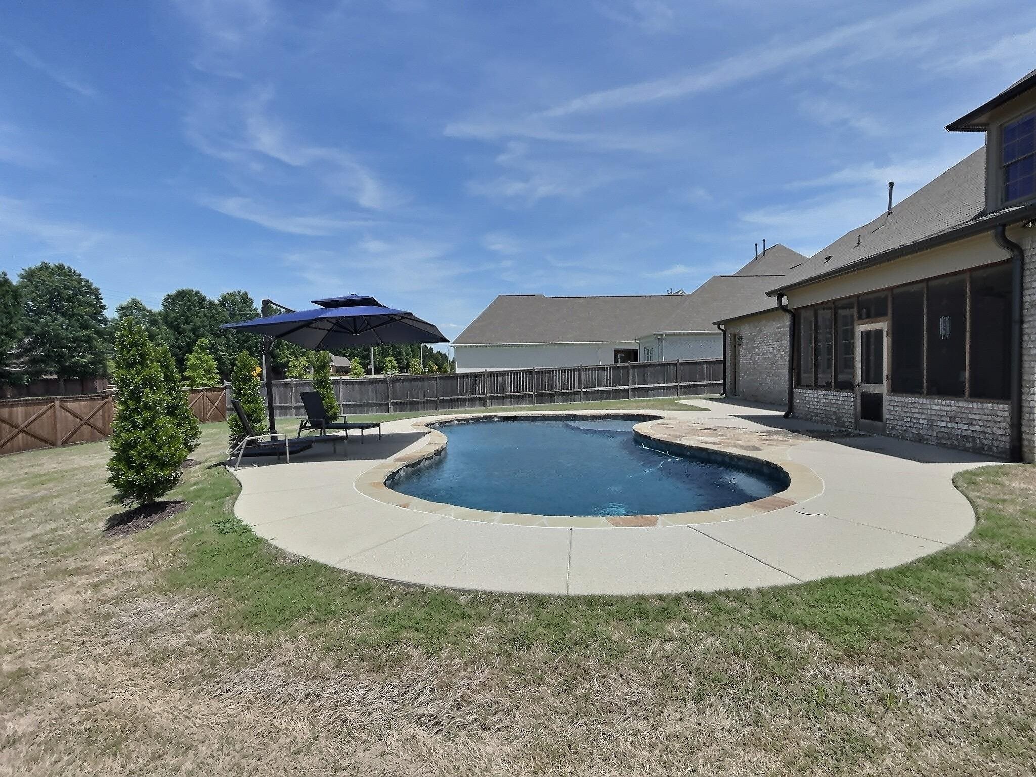 1254 Percheron Pass Collierville, TN 38017 - Photo 30 of 32 a view of a house with swimming pool and a yard