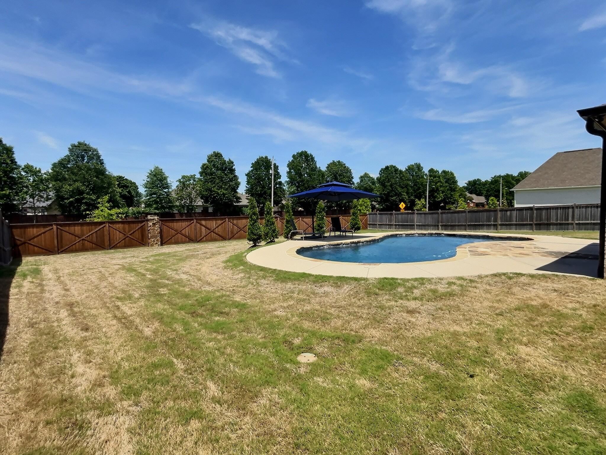 1254 Percheron Pass Collierville, TN 38017 - Photo 32 of 32 a view of a swimming pool with a yard