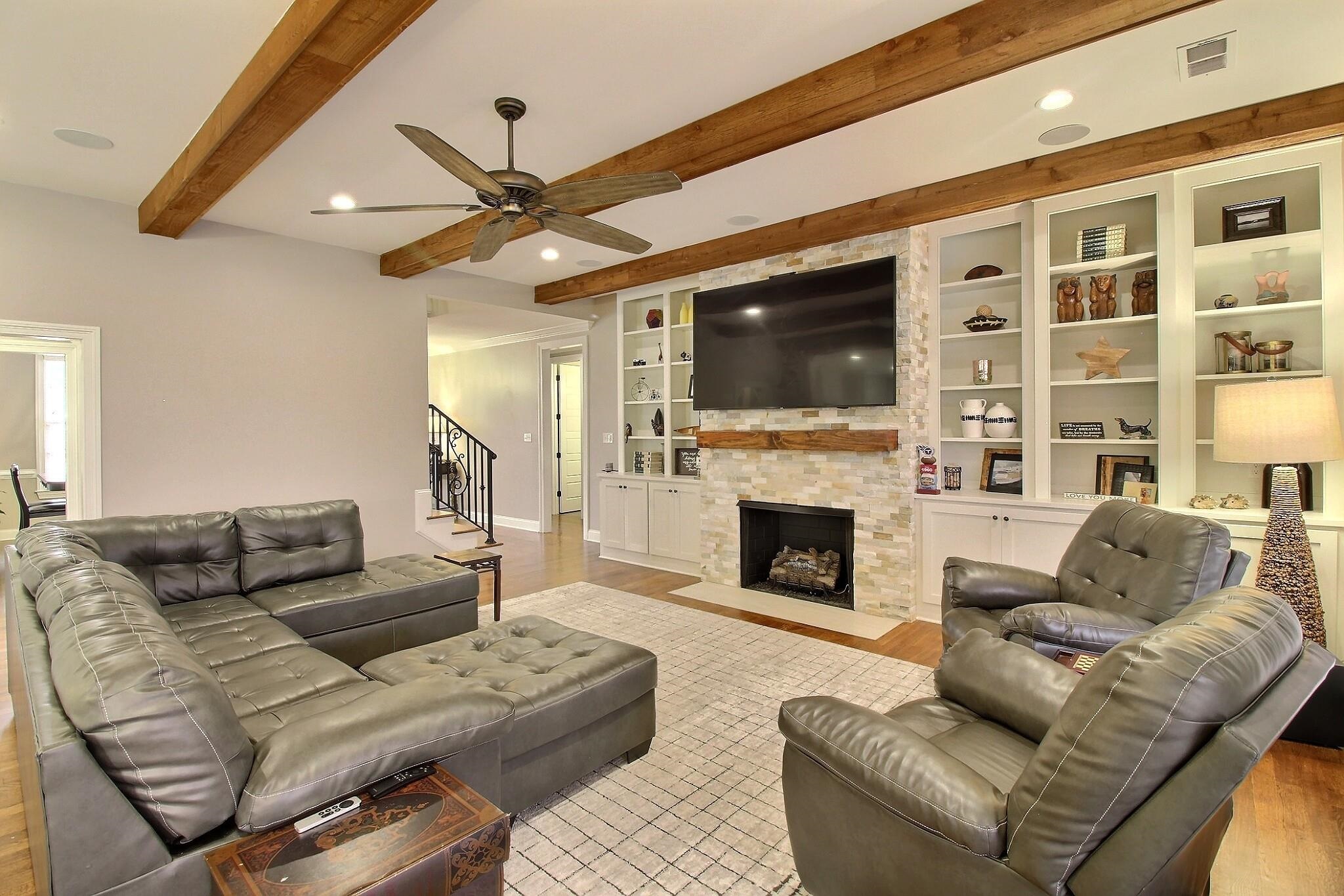 1254 Percheron Pass Collierville, TN 38017 - Photo 4 of 32 a living room with furniture a fireplace and a flat screen tv