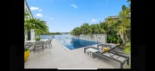 a view of a lake with couches in wooden deck
