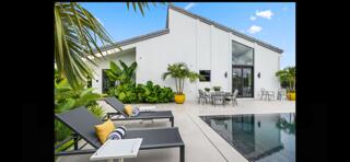 6110 North Ocean Boulevard, Unit 39 Ocean Ridge, FL 33435 - Photo 13 of 33 a view of swimming pool with outdoor seating and plants
