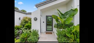 6110 North Ocean Boulevard, Unit 39 Ocean Ridge, FL 33435 - Photo 28 of 33 a front view of a house with a yard