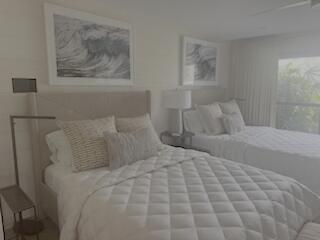 6110 North Ocean Boulevard, Unit 39 Ocean Ridge, FL 33435 - Photo 10 of 33 a bedroom with a bed and painting on the wall