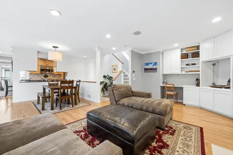 a living room kitchen with furniture and kitchen view