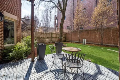 a view of a chairs and table in backyard of the house