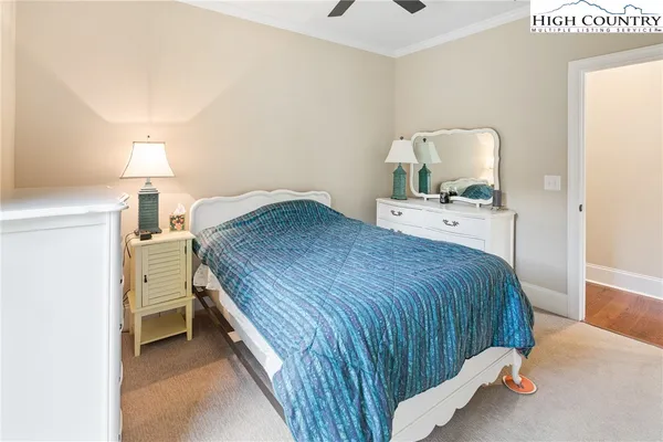 a bedroom with a bed and a lamp