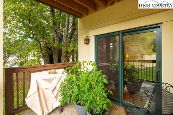 a view of a balcony with chair and table in the patio