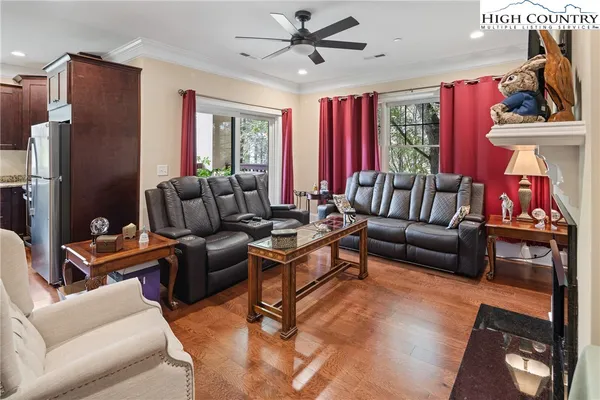 a living room with furniture ceiling fan and a window