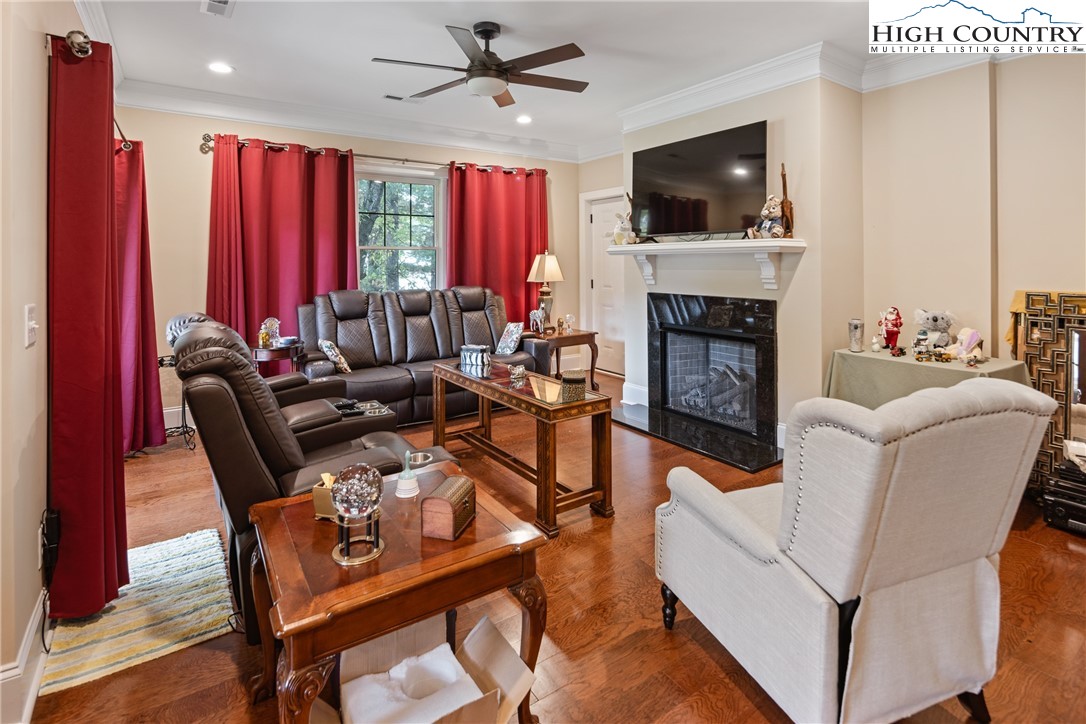 155 Gateway Drive, Unit 201 Boone, NC 28607 - Photo 7 of 23 a living room with furniture a flat screen tv and a fireplace