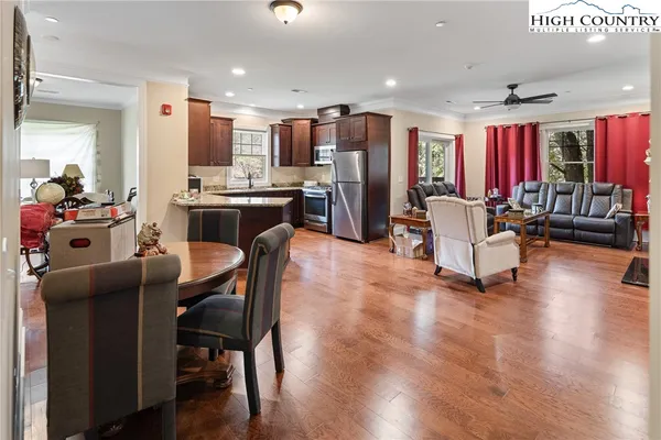 a living room with furniture and kitchen view