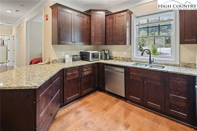 a kitchen with a sink a stove and cabinets