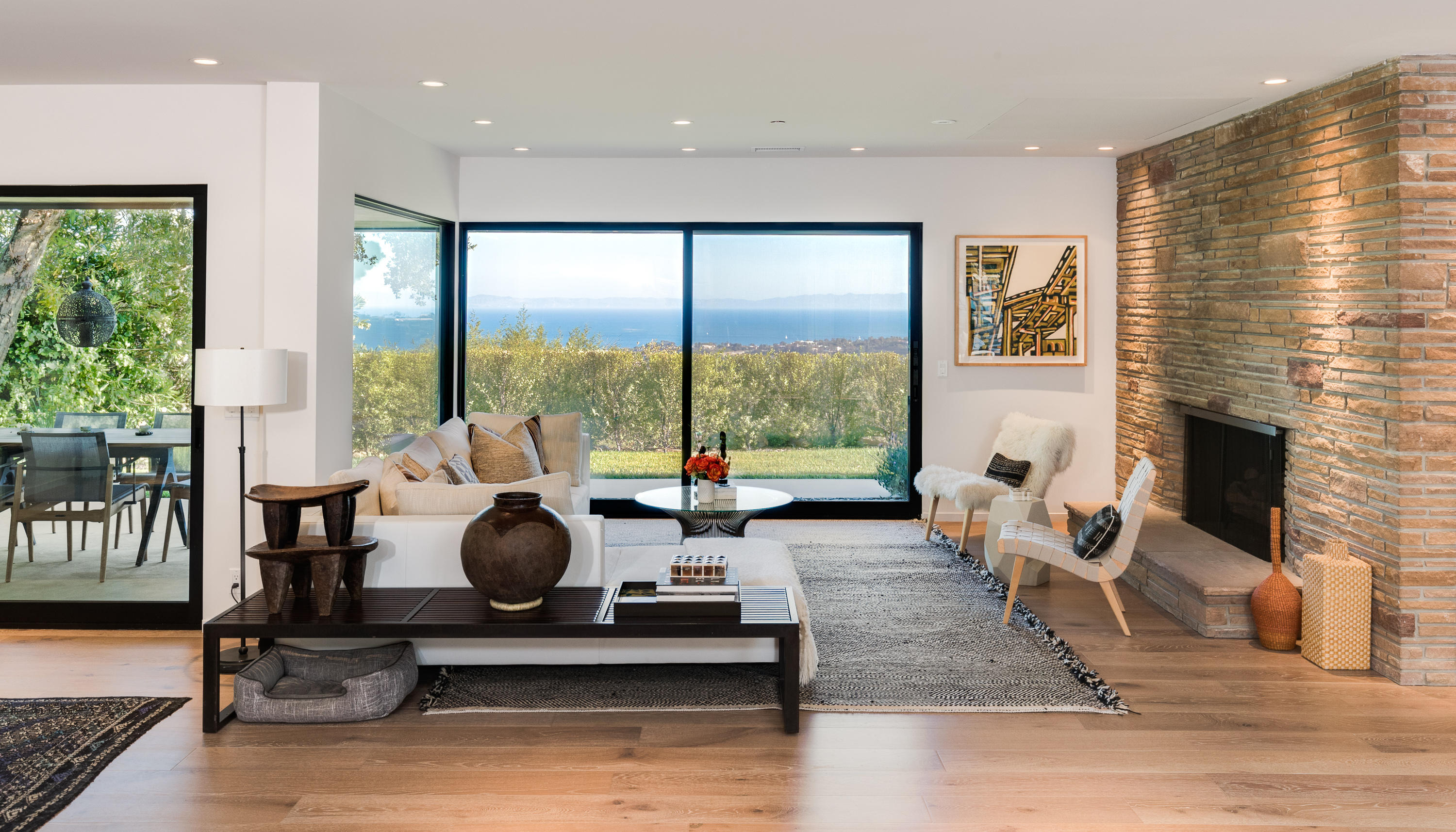 1830 Mission Ridge Road Santa Barbara, CA 93103 - Photo 1 of 4 a living room with fireplace furniture and floor to ceiling windows