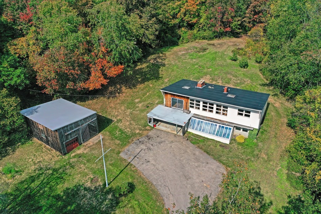 1167 Lower Road Hardwick, MA 01031 - Photo 15 of 42 an aerial view of a house with garden space and trees all around