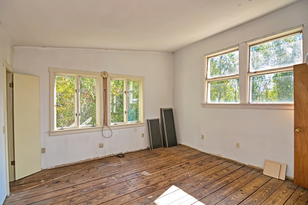 1167 Lower Road Hardwick, MA 01031 - Photo 19 of 42 a view of a bedroom with wooden floor and a window