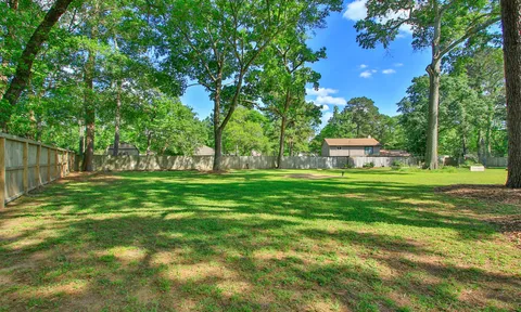 a front view of house with yard and trees