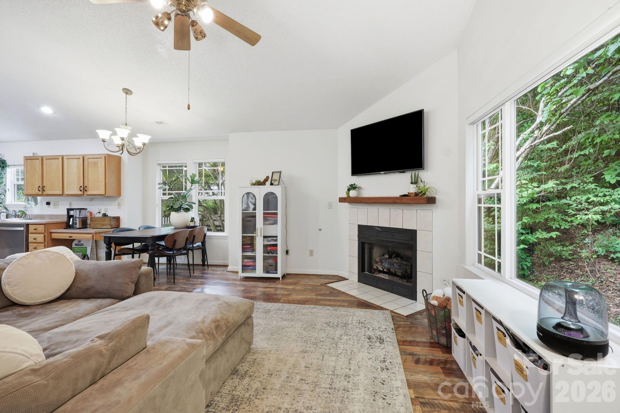 51 Sunview Circle Arden, NC 28704 - Photo 4 of 31 a living room with furniture a fireplace and a flat screen tv