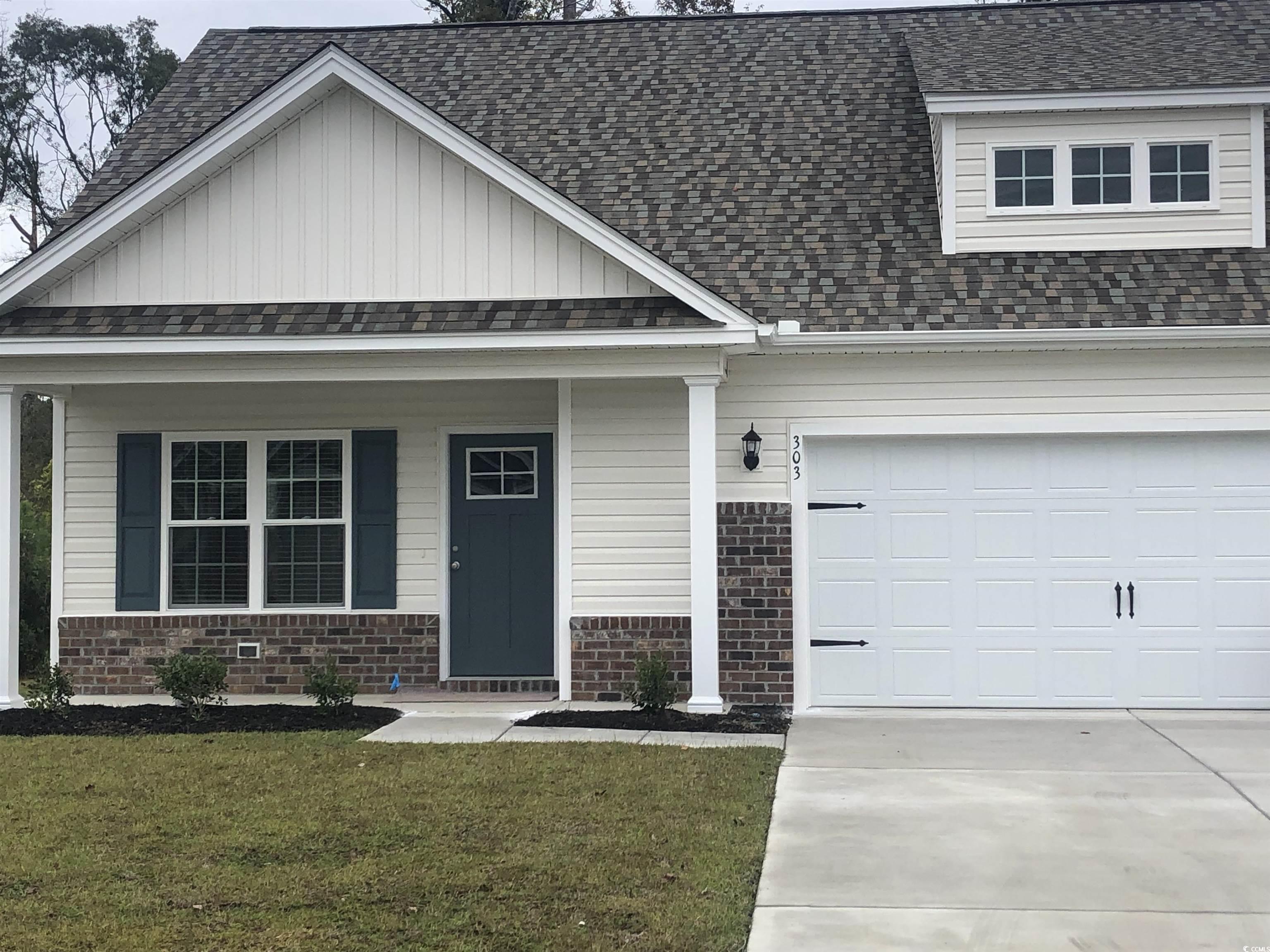 303 Lakota Loop Longs, SC 29568 - Photo 1 of 17 Craftsman house with covered porch, a garage, and