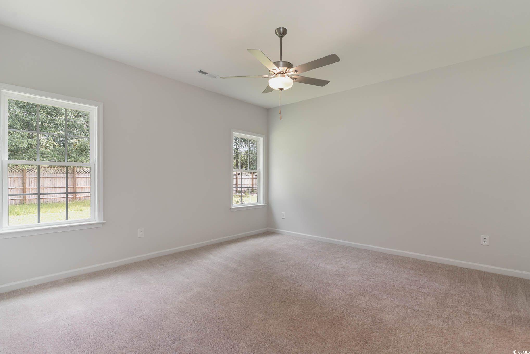 303 Lakota Loop Longs, SC 29568 - Photo 12 of 17 Carpeted empty room featuring ceiling fan