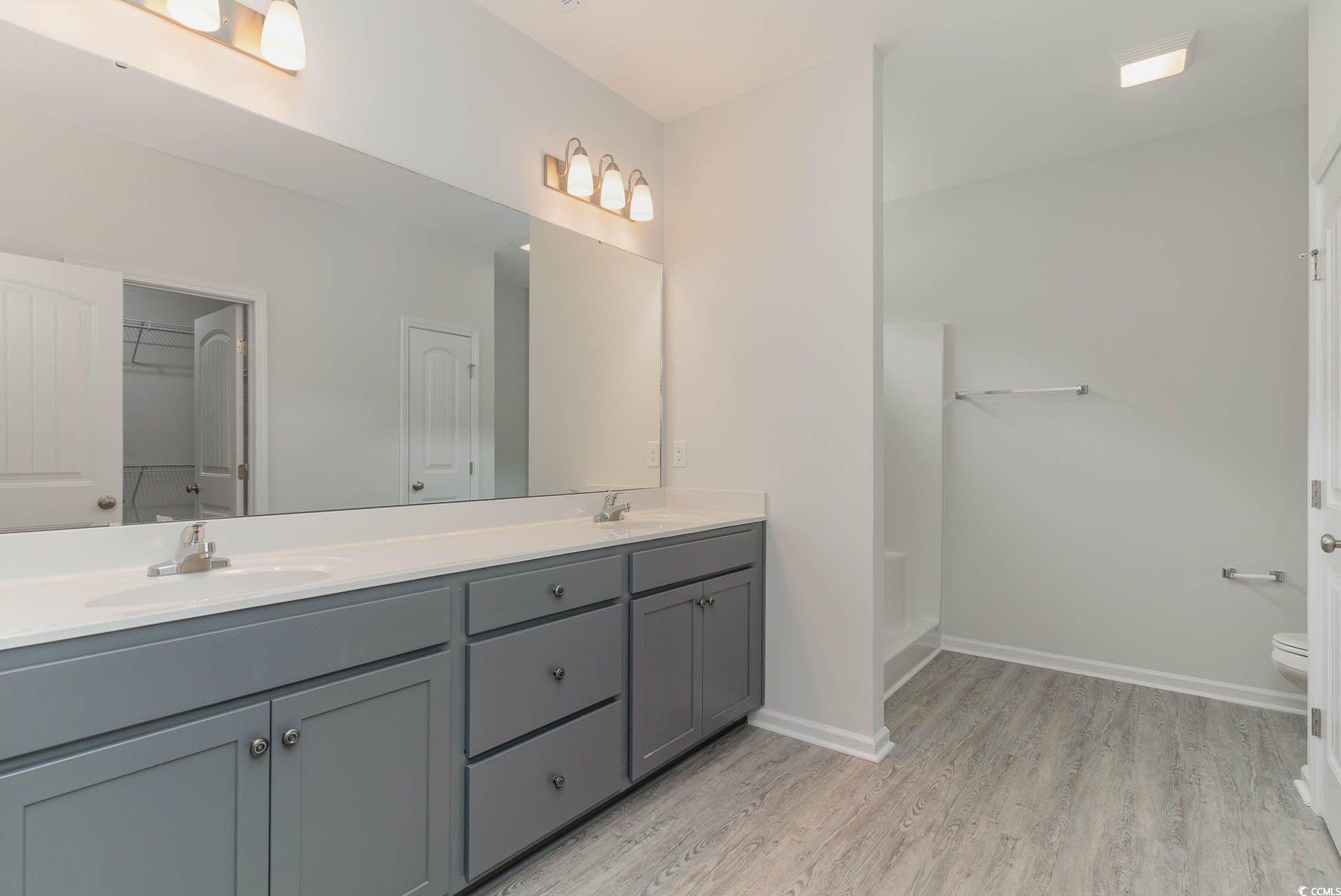 303 Lakota Loop Longs, SC 29568 - Photo 13 of 17 Bathroom featuring dual vanity, hardwood / wood-st