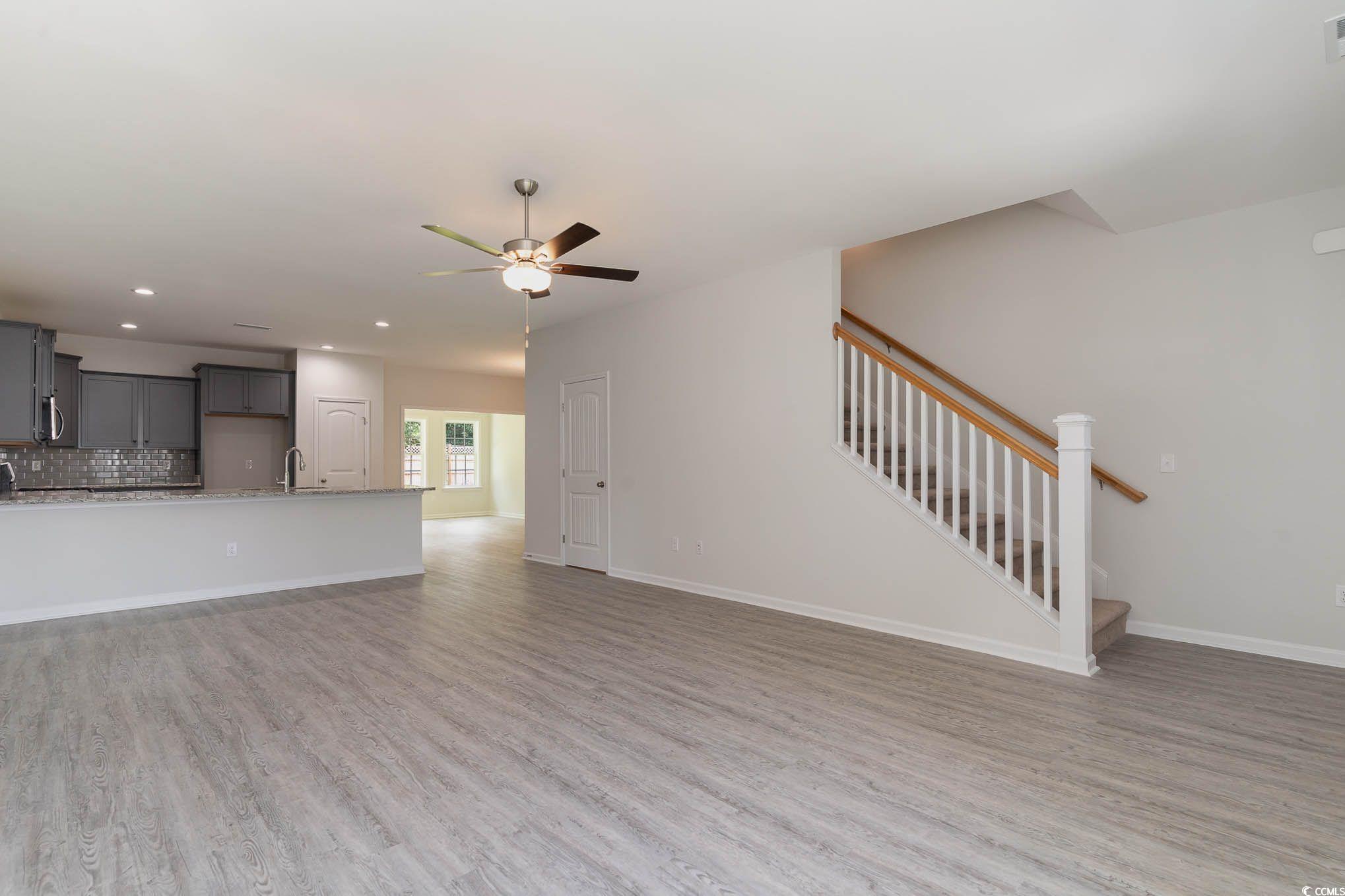303 Lakota Loop Longs, SC 29568 - Photo 15 of 17 Unfurnished living room with ceiling fan, sink, an