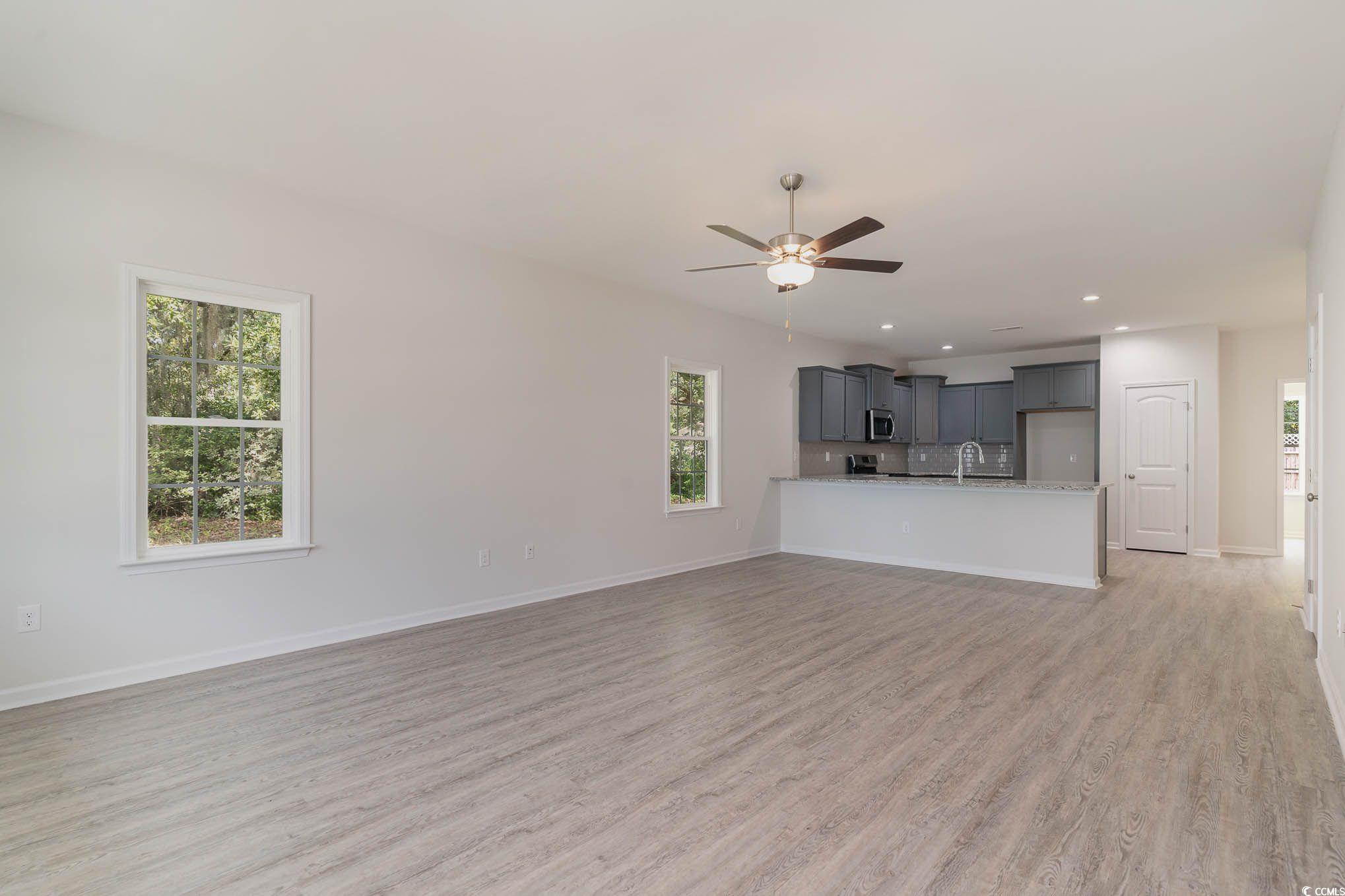 303 Lakota Loop Longs, SC 29568 - Photo 2 of 17 Unfurnished living room featuring light hardwood /