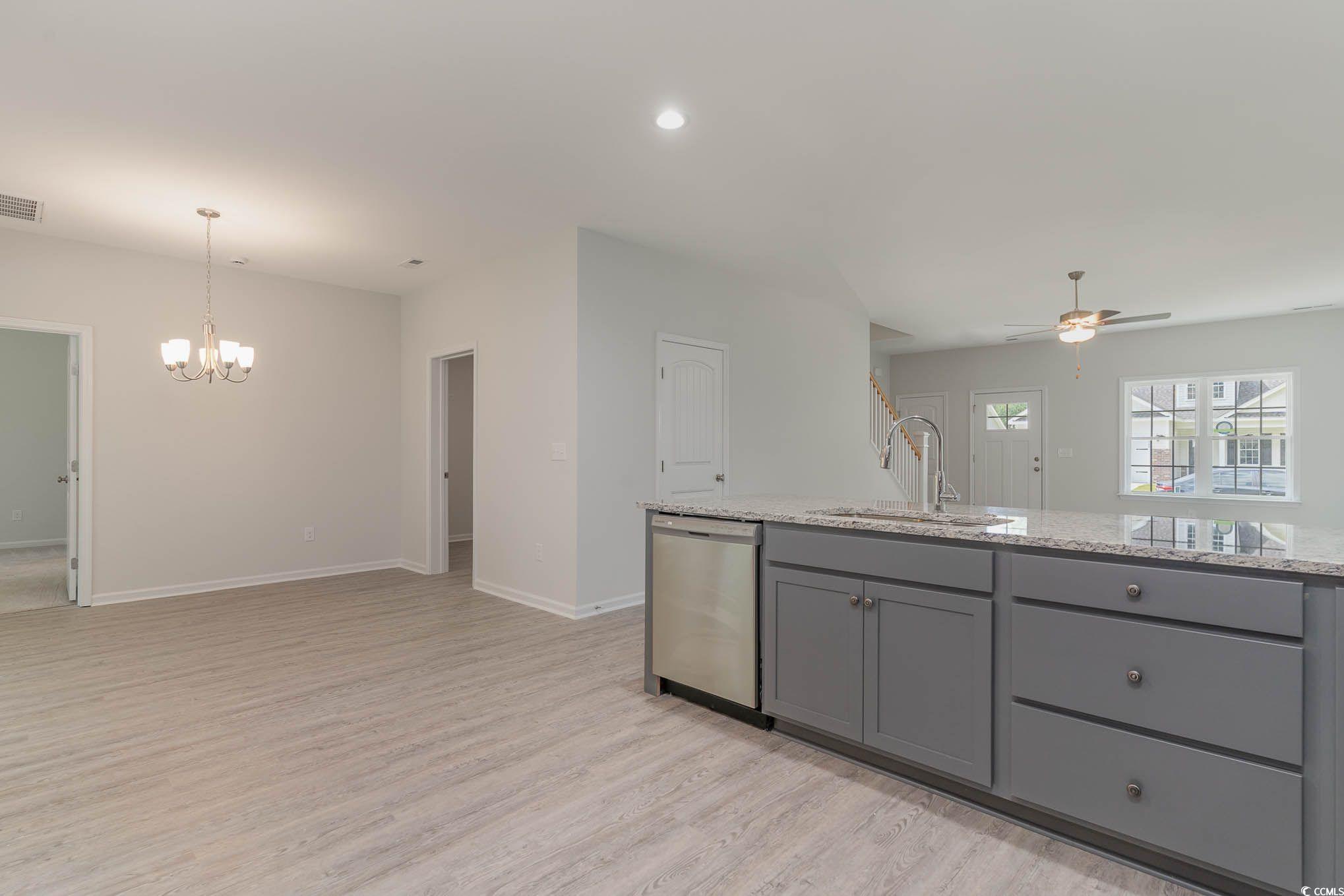 303 Lakota Loop Longs, SC 29568 - Photo 6 of 17 Kitchen with stainless steel dishwasher, light woo
