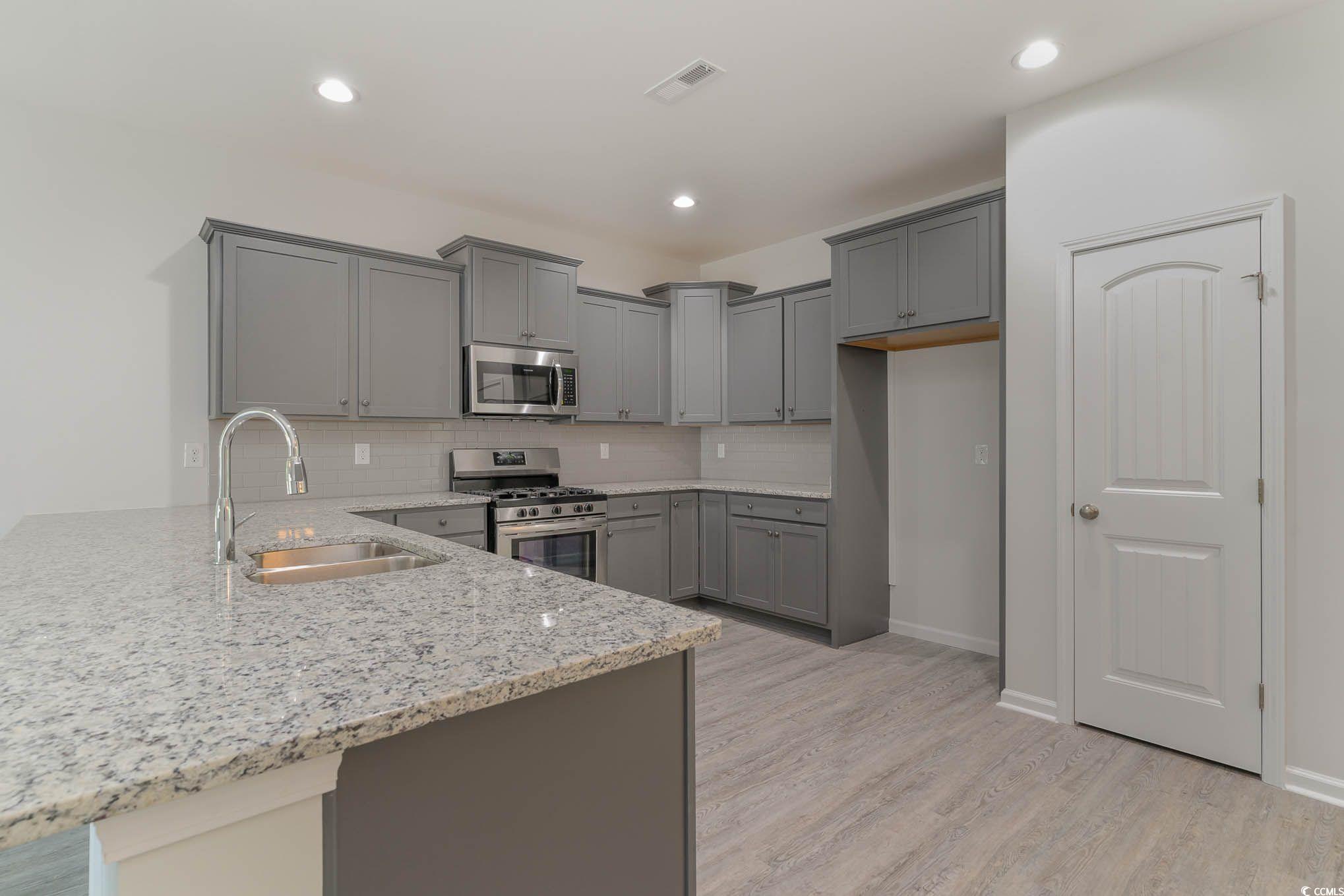 303 Lakota Loop Longs, SC 29568 - Photo 7 of 17 Kitchen with light hardwood / wood-style flooring,