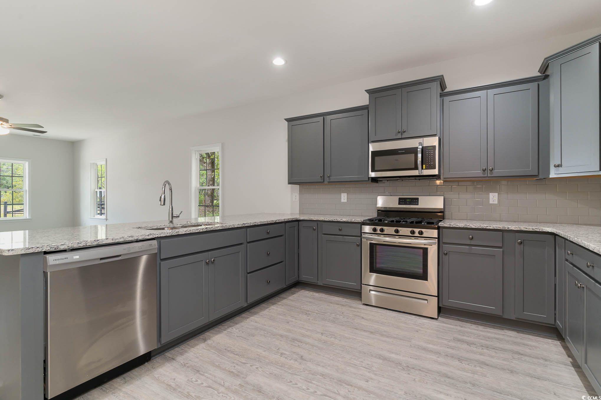 303 Lakota Loop Longs, SC 29568 - Photo 8 of 17 Kitchen featuring stainless steel appliances, ligh