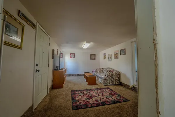 a living room with furniture rug and wooden floor