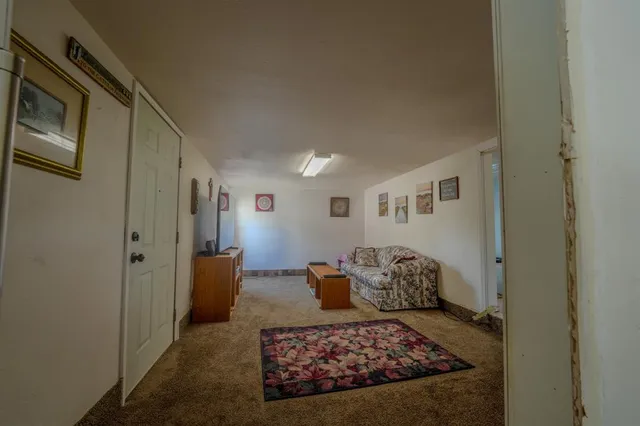 a living room with furniture rug and wooden floor