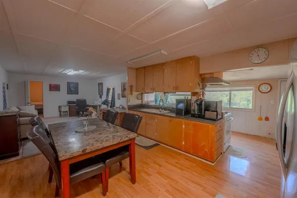 a kitchen with stainless steel appliances granite countertop a stove refrigerator and cabinets