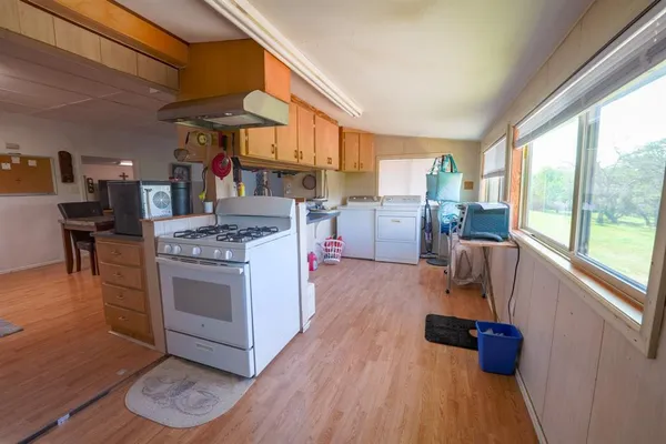 a kitchen with stainless steel appliances granite countertop a stove and a sink