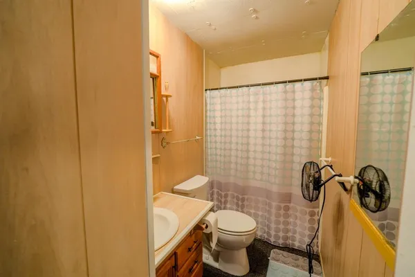 a bathroom with a toilet and a shower
