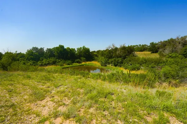 a view of a lake with houses in the background